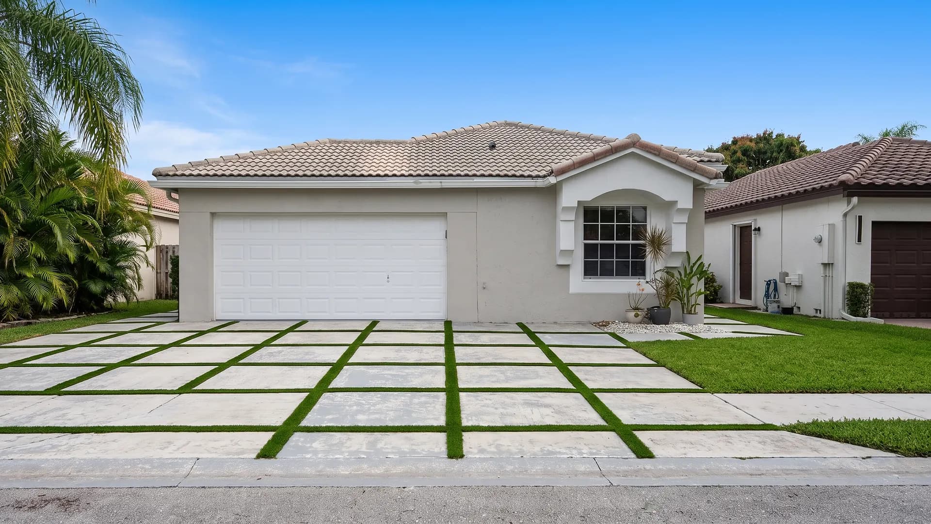 Slab paver driveway with artificial turf joints in South Florida