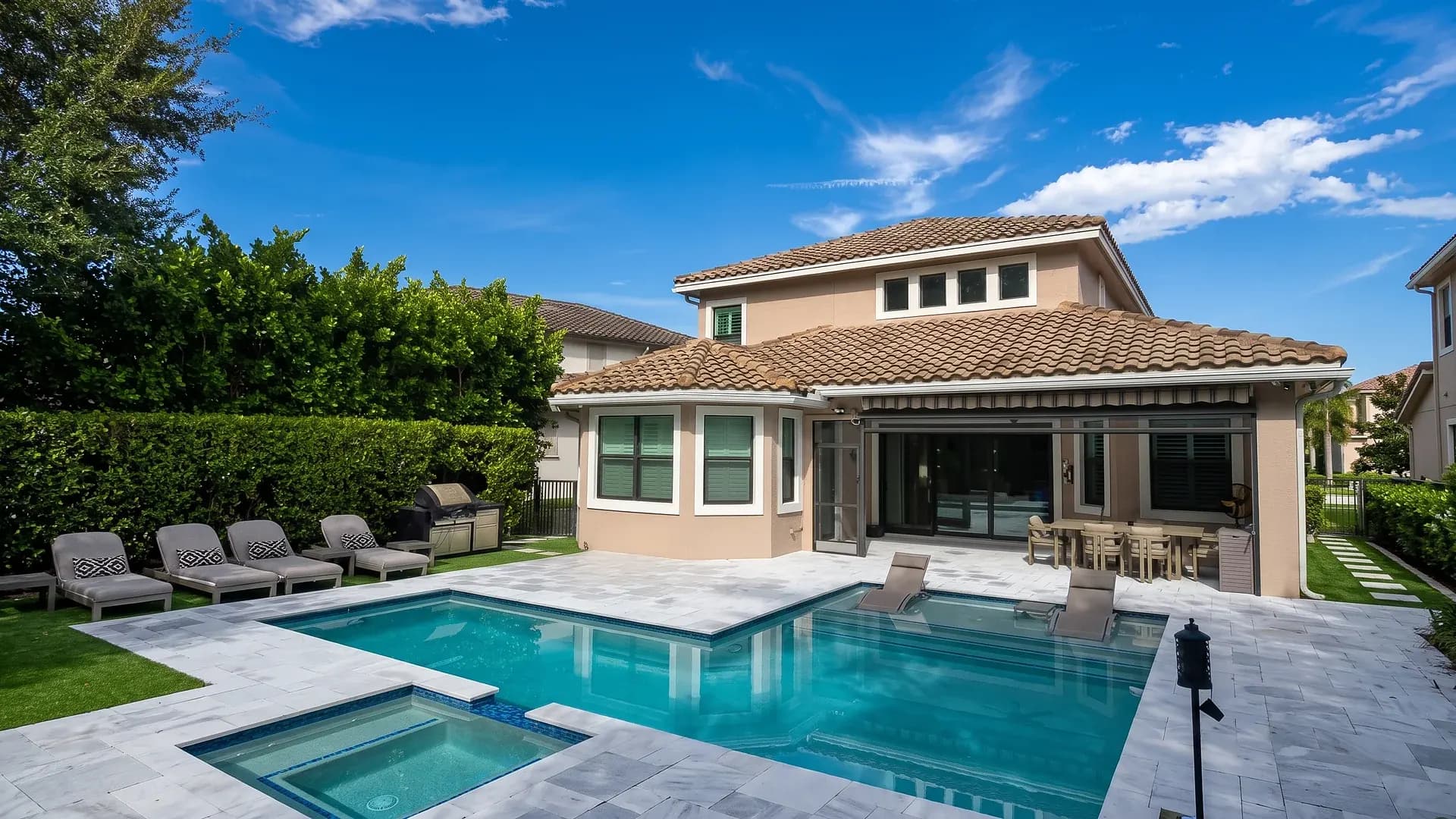 Stone pool deck and spa installed by TL Pavers