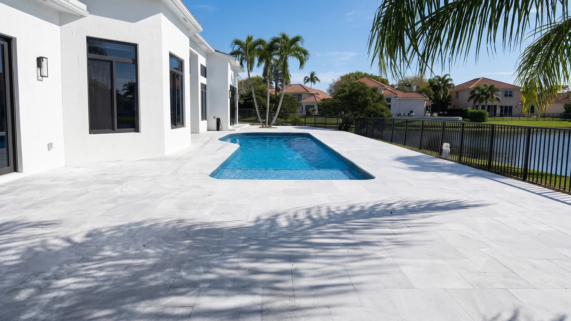 Grey stone paver pool deck around a rectangular pool