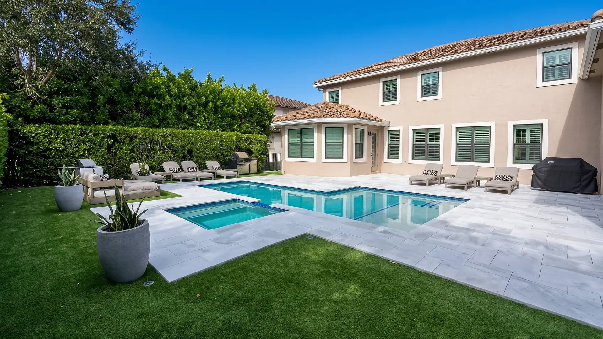 Pool deck with spa and turf in Broward County